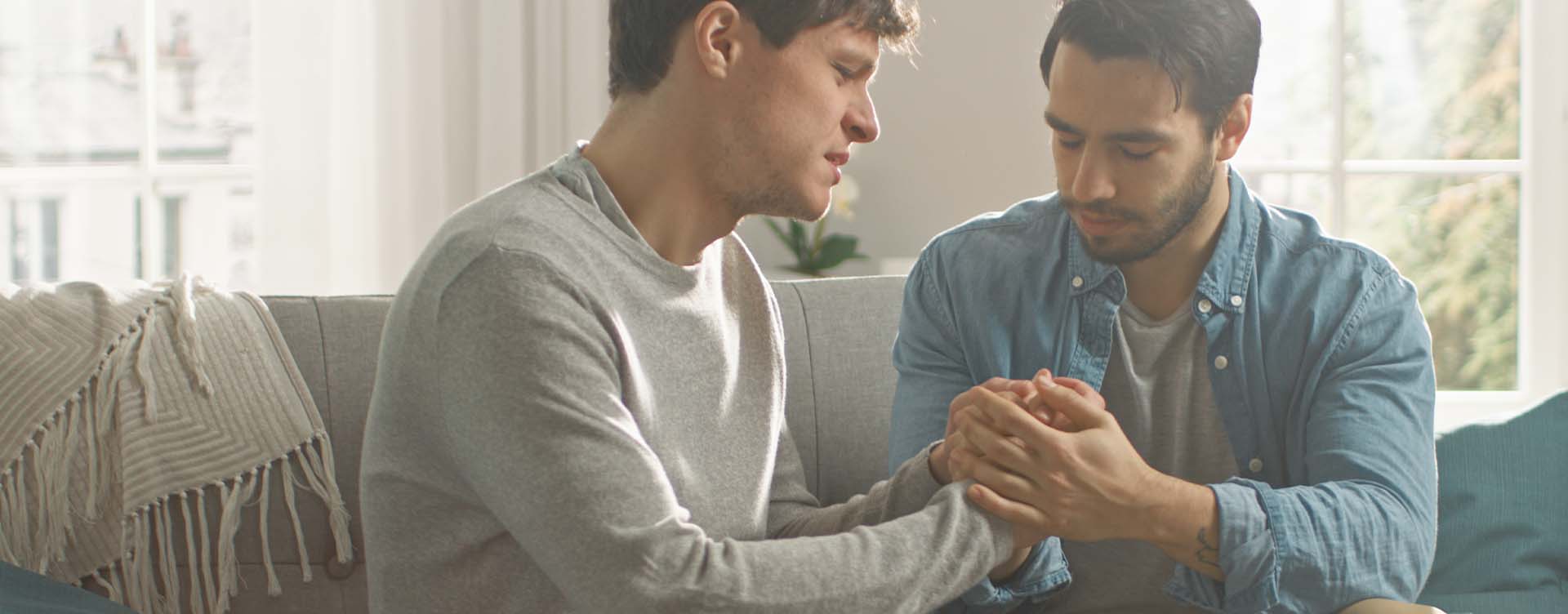 Two men holding hands